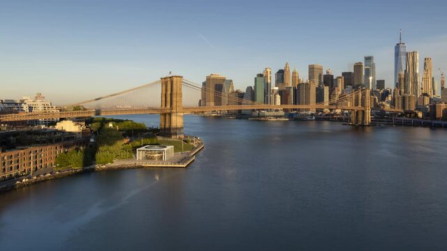 Aerial View on Financial District from East river with Brooklyn bridge in sunrise time lapse