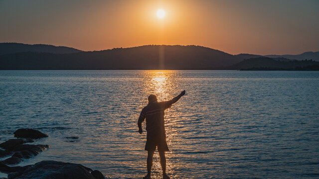 silhouette of Fisherman at the sunset at the sea