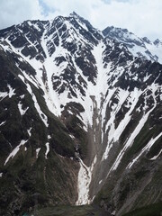 Beautiful view of the melting snow Cheget mountains in summer in Sunny weather.