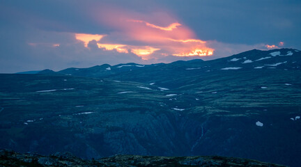 Landscape scenery with pink skies during sunset in the norwegian mountains near Rondane national park.