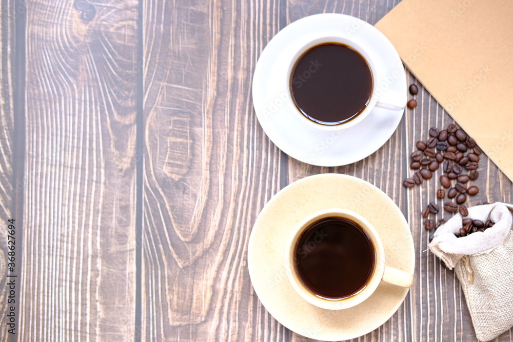 Poster coffee cup and coffee beans on old wood table background, space for text