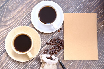 cup of coffee with a notebook and a pen