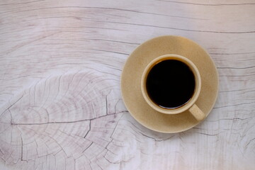 coffee cup and coffee beans on old wood table background, space for text