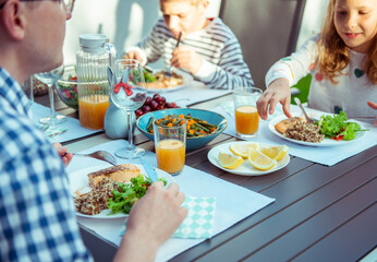 Obraz na płótnie Canvas Happy family eating healthy dinner on terrace at home
