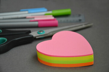 Heart shaped sticky notes, colored pens and scissors