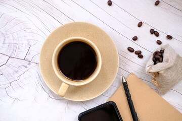 Top view coffee cup and coffee beans on old wood table background