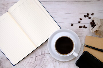 Top view coffee cup and coffee beans on old wood table background