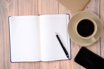 a cup of coffee on wood table and space for text