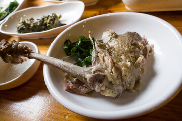 Bones of boiled chicken legs with meat from soup.
