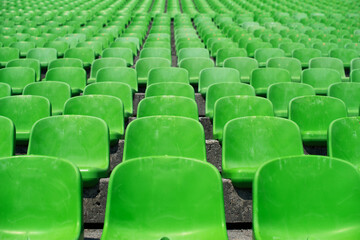 rows of green stadium seats 