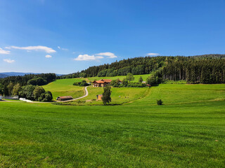 Fototapeta na wymiar Idyllic alpine landscape scenery with farmhouse and green meadows, Bodenmais, Bavaria, Germany