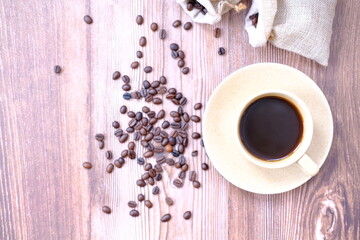 Top view coffee cup and coffee beans on old wood table background, space for text