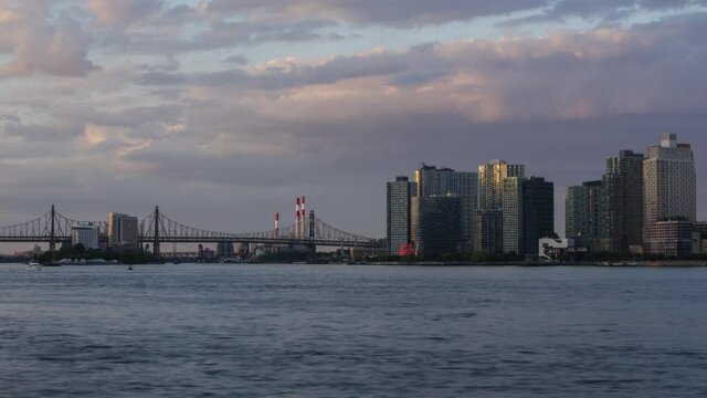 View on Queens Skyline with Queensboro bridge from East River with day to night time lapse