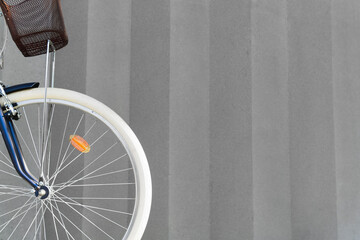 Front wheel of a hipster bike on a grey background