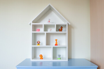 a wooden dollhouse with toy