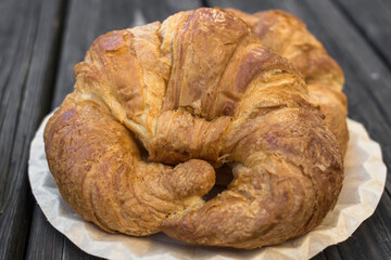 Fresh bakery. Crispy croissant. Cozy background for cafe and coffee shop. Tasty food. Fast breakfast. Restaurant theme. Morning meal. Curved burger. French bagel.