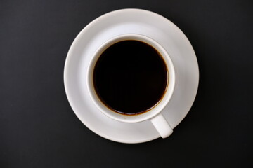 cup of coffee and coffee beans on table background