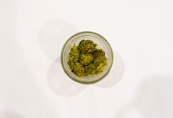 Top down view of mason jar filled with marijuana nugs. Weed background concept