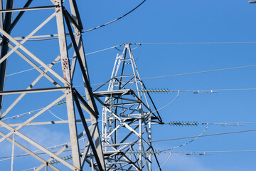 Grey steel hydro electric towers against blue sky