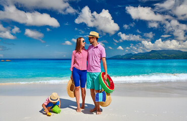 Family with three year old boy on beach. Seychelles, Mahe.