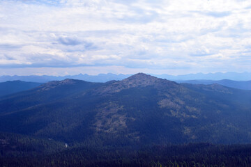 Beautiful view of the mountains. Tall firs. Mountain range. Panoramic view. Nature of Siberia. Sense of freedom. Independent tourism. Krasnoyarsk region. Tourist routes in Siberia.