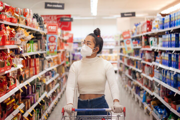 Young Asian women wearing face mask with canvas bag buying in supermarket.Panic shopping during Covid-19, Sydney Australia.