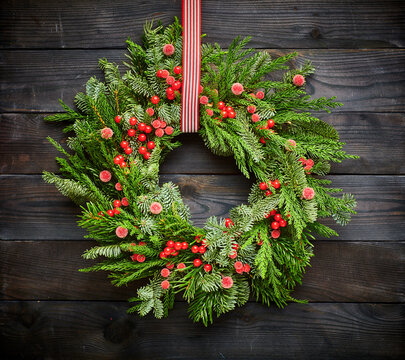 Christmas wreath on dark wooden background