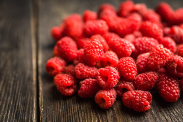 Freshly harvested raspberry on the rustic wooden background. Selective focus. Shallow depth of field.
