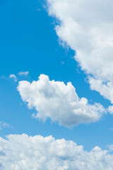Obraz na płótnie Canvas White clouds with blue sky. Vertical shot.
