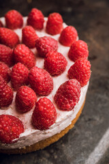 Fresh cheesecake with raspberries on the rustic background. Selective focus. Shallow depth of field.
