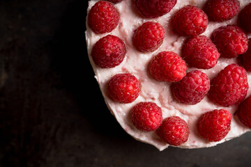 Fresh cheesecake with raspberries on the rustic background. Selective focus. Shallow depth of field.
