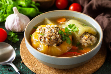 Healthy food. Bell stuffed paprika peppers with meat and bulgur in broth with vegetables.