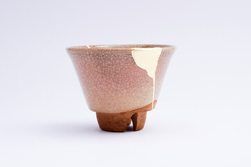 Antique Japanese kintsugi sake cup. Handmade ceramic restored with the ancient traditional Japanese technique.