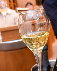 glass of white wine close-up blurred background