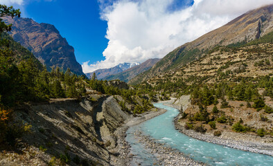 Marshyangdi river and views of alpine forest and mountains near Pisang in Manang of Nepal in the Annapurna Circuit trekking trail.