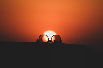 Fototapeta na wymiar Sunglasses and a sunset