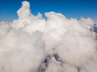 High flight in white curly clouds.