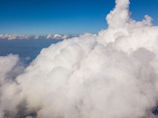 High flight in white curly clouds.