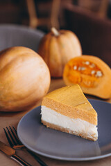 Slices of Freshly Baked Pumpkin Pie on cozy cafe background, selective focus, noise effect