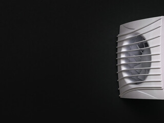 White exhaust fan on a black background.