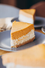 Piece of pumpkin homemade cake. Festive dessert concept. pumpkin tart on cozy cafe background, selective focus, noise effect
