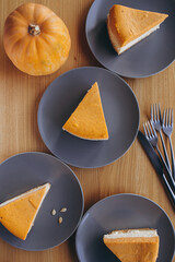 Piece of pumpkin homemade cake. Festive dessert concept. pumpkin tart on cozy cafe background, selective focus, noise effect