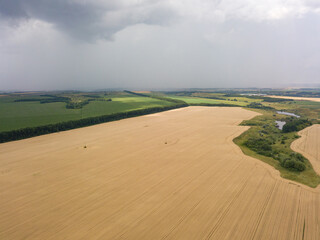 Obraz premium Aerila drone view. Summer rain over agricultural fields in Ukraine.