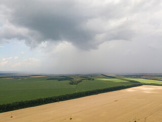 Aerila drone view. Summer rain over agricultural fields in Ukraine.