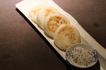 close up rice cakes and sugar on plate on table. Traditional Chinese food