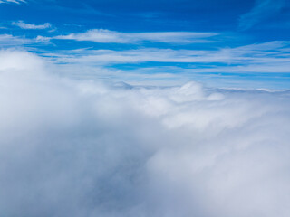 Fototapeta premium High flight in white curly clouds.
