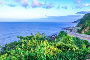 Sea side street near the mountain with blue sky in clear day.