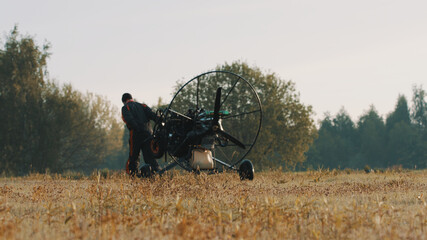 Paramotorgliding. Man succesfully landed on the field. High quality photo