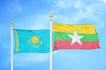 Kazakhstan and Myanmar two flags on flagpoles and blue sky