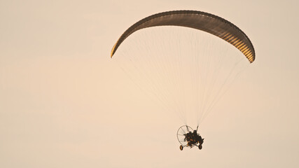 Paramotor Tandem Gliding And Flying In The Air. Copy space. High quality photo